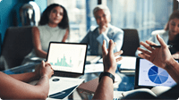 people-sitting-in-a-meeting-looking-at-graph-on-laptop