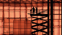 Workers on a scissor lift at a construction site