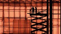Workers on a scissor lift at a construction site
