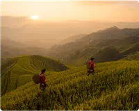 two people walking in mountains sunrise
