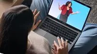 Project professional watching PMXPO on laptop