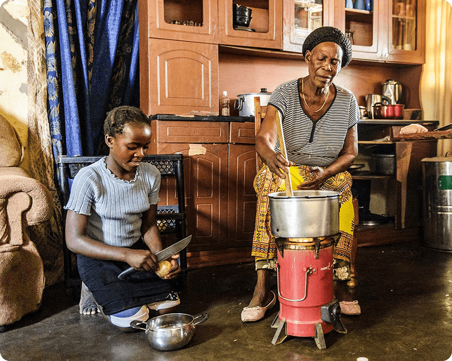 A woman and young girl doing household chores