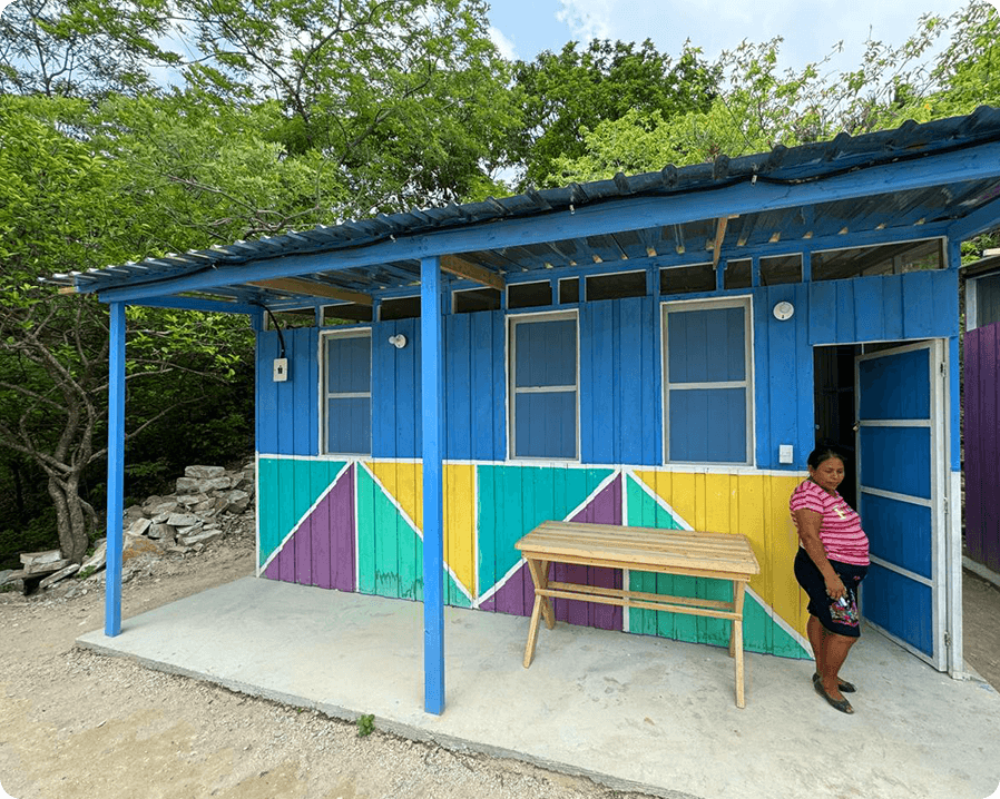 Woman standing in front of a colorfully painted building
