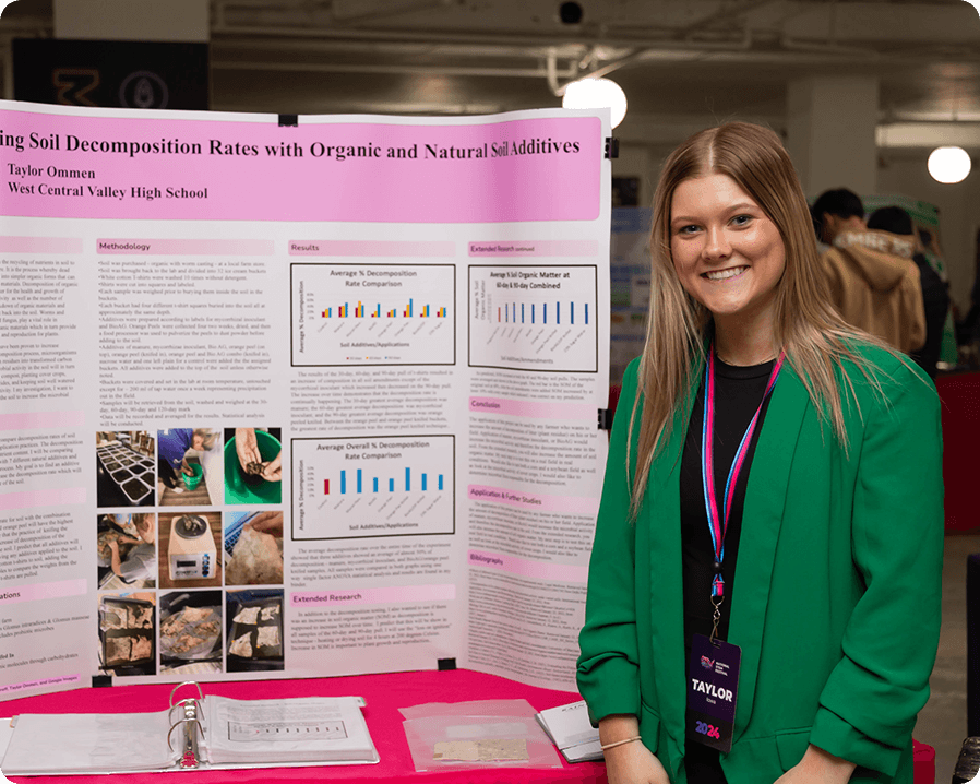 Teenage girl standing next to a posterboard presentation