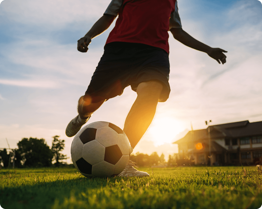 A man kicking a soccer ball
