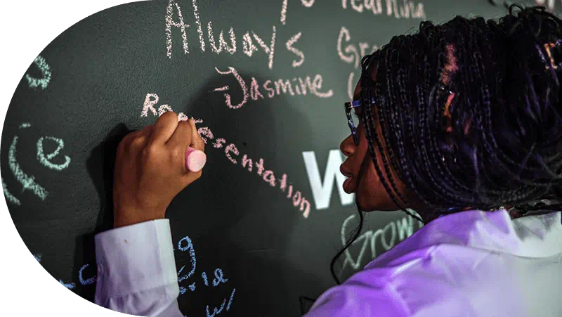 Girl writing on a chalkboard