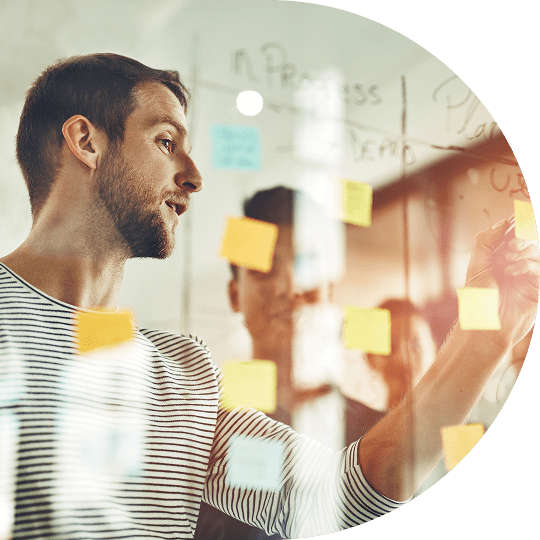 project-professional-looking-at-sticky-notes
