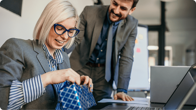 woman-opening-gift-at-desk