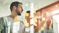 Agile-certified project professionals organizing tasks in a scrum.