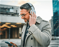 Man with headphones holding phone