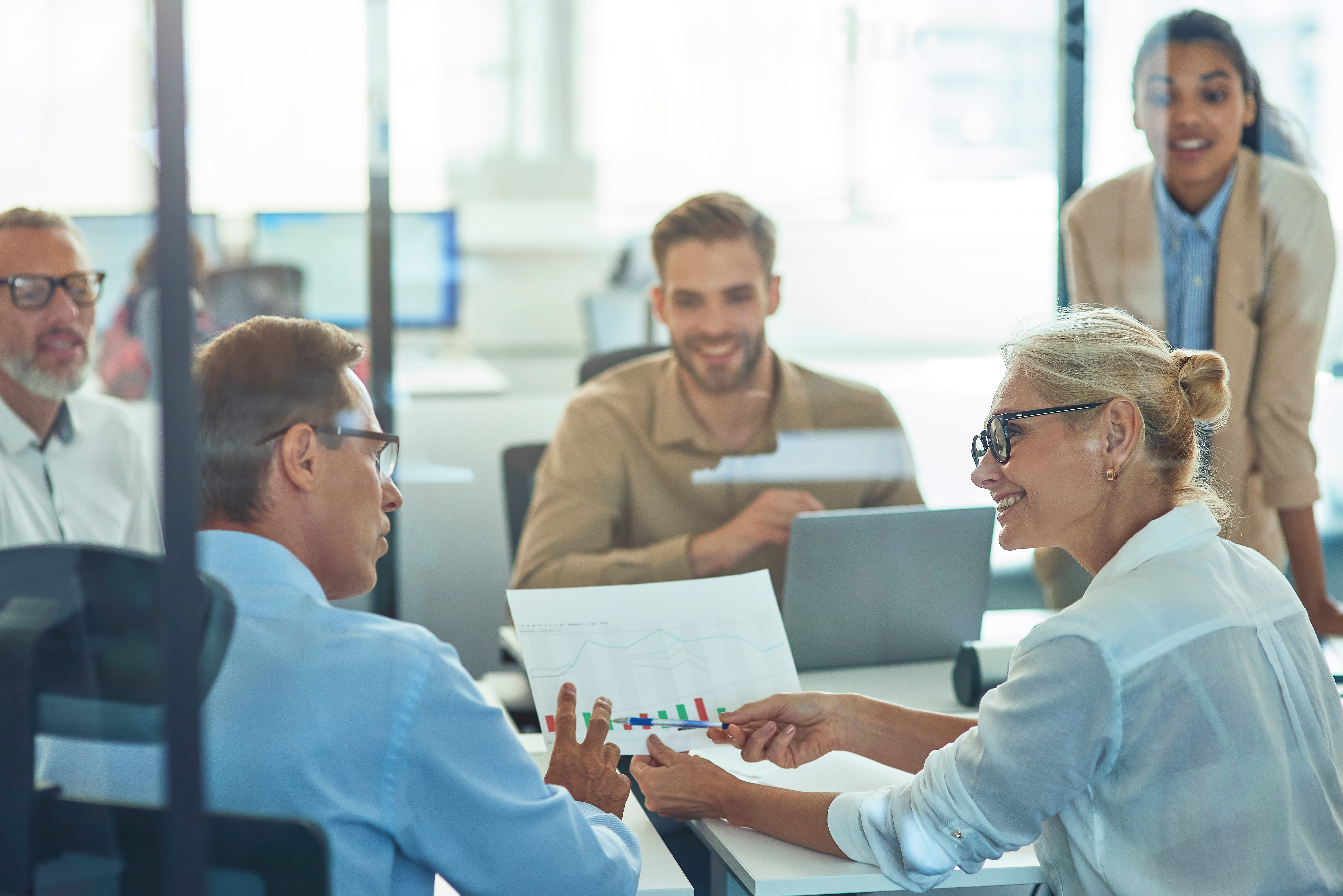 men-and-women-at-table-looking-at-charts