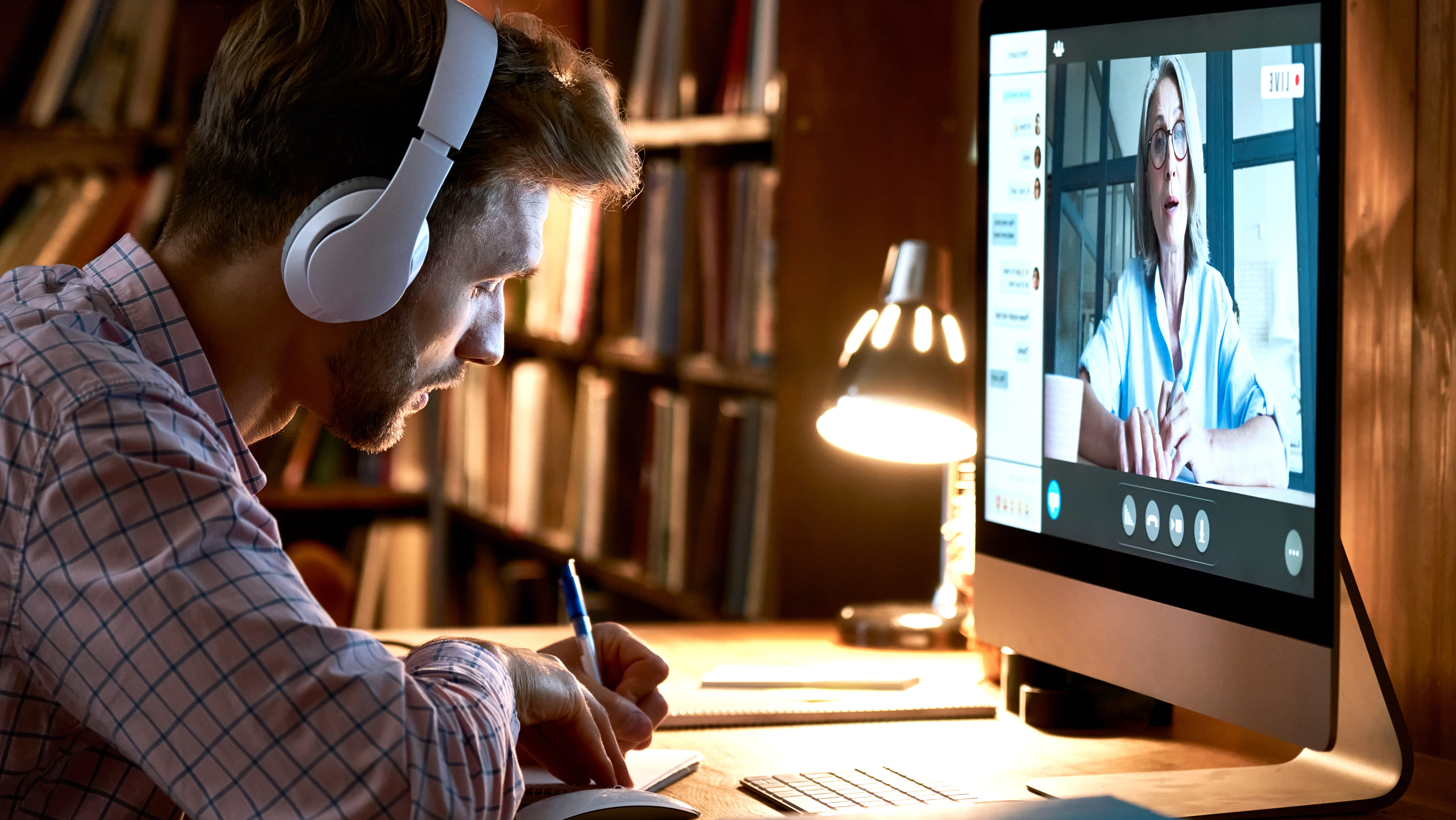 man-with-headphones-listening-to-training-on-computer