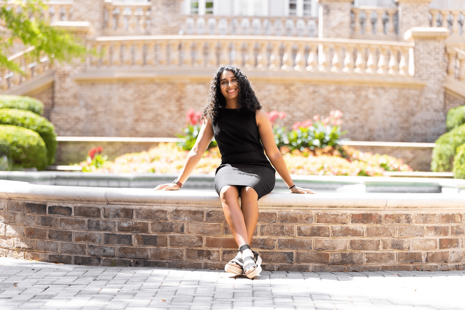 Bela-Sanghavi-sitting-on-brick-wall