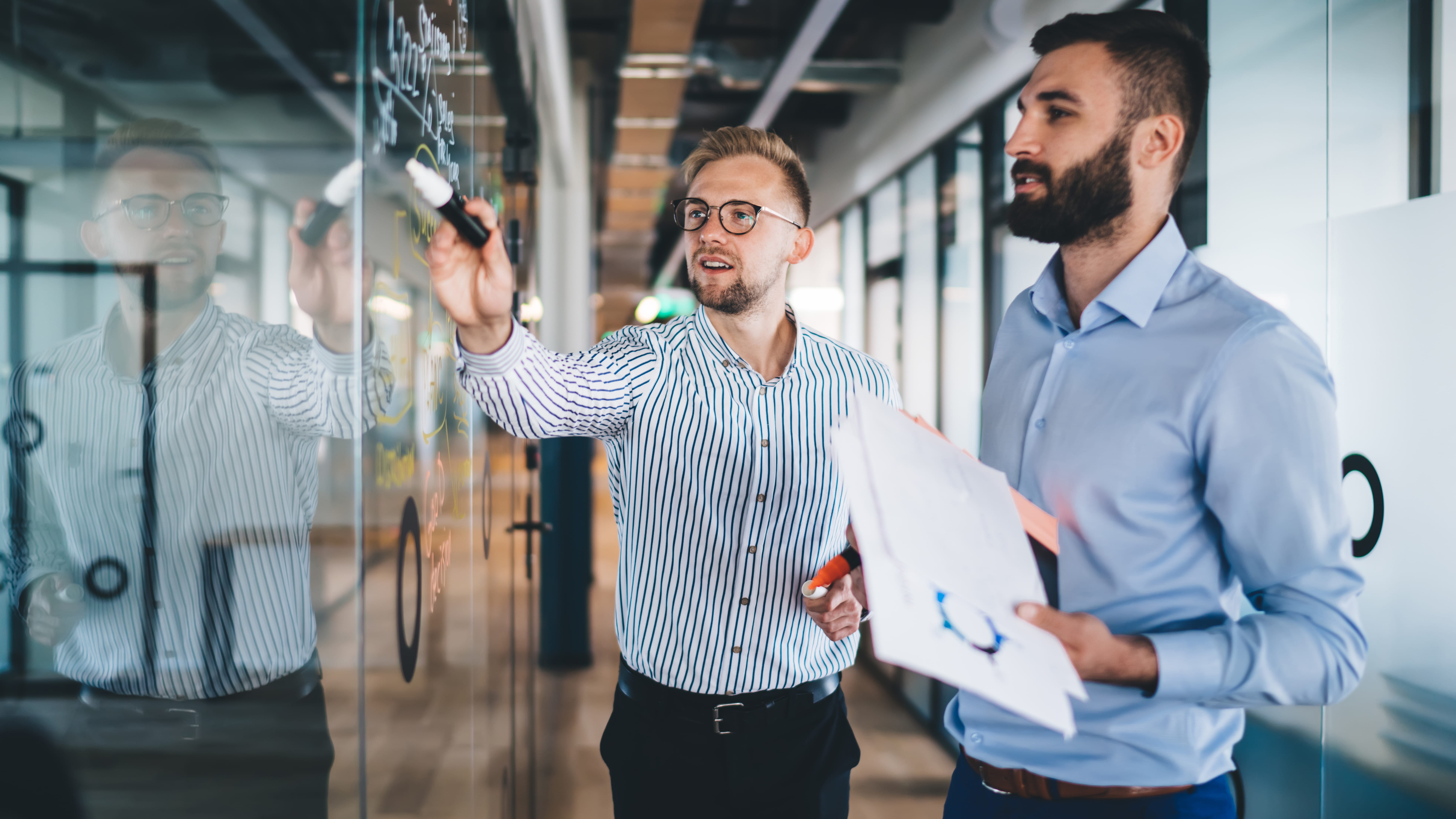 two-men-working-at-a-white-board