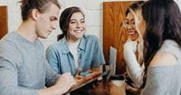 four-people-smiling-at-eachother