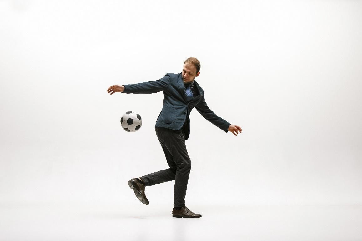 Man in a suit with a black and white checkered ball