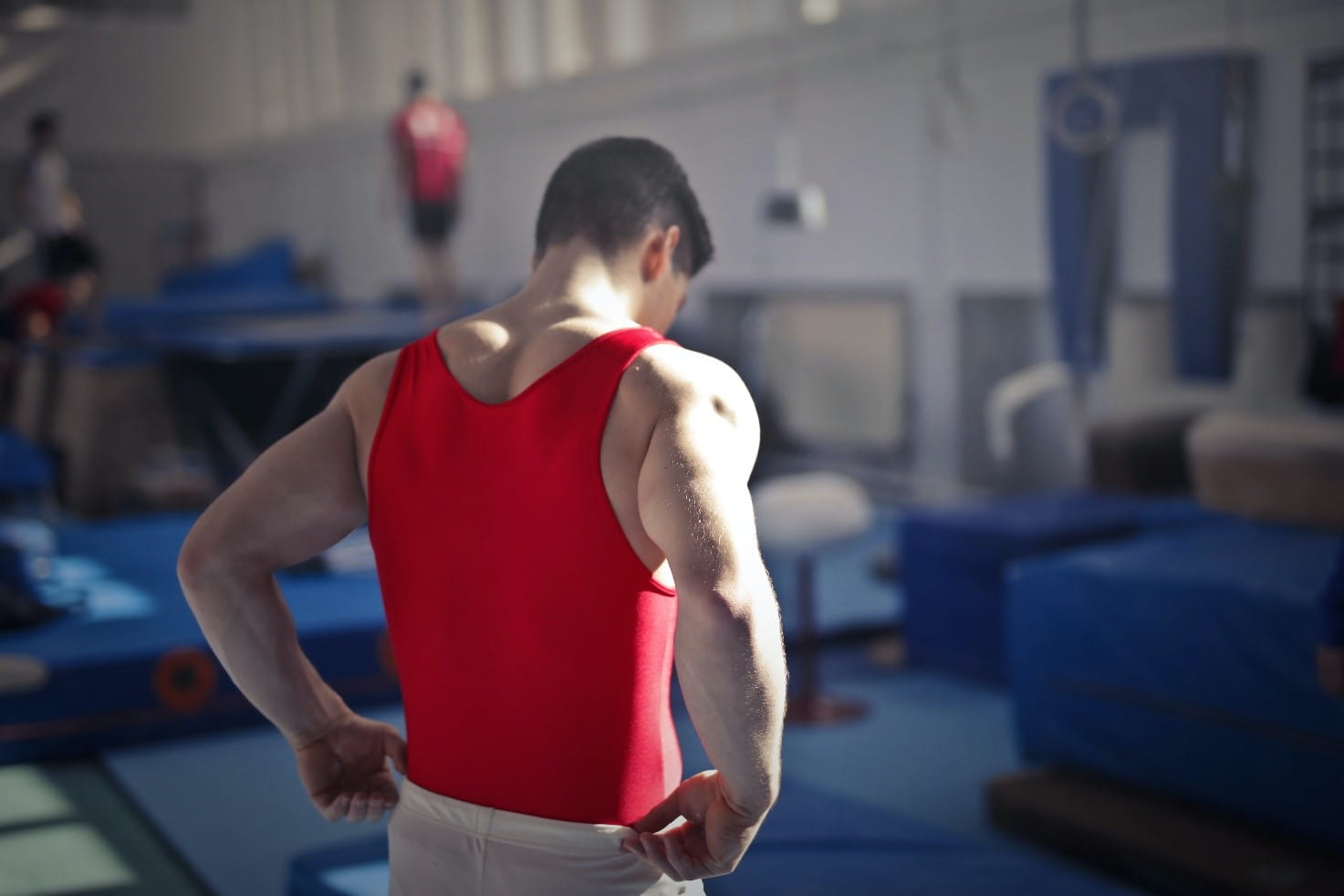 Gymnastics image, guy in red shirt