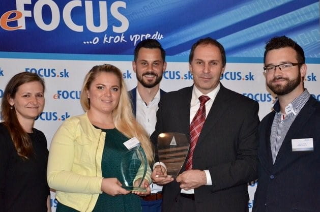 Group with two awards in front of the eFocus.sk banner