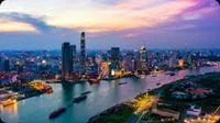 Ho Chi Minh City skyline beside the river at dusk.