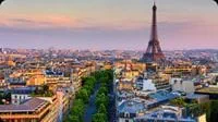 Paris rooftops and the Eiffel Tower at sunset.