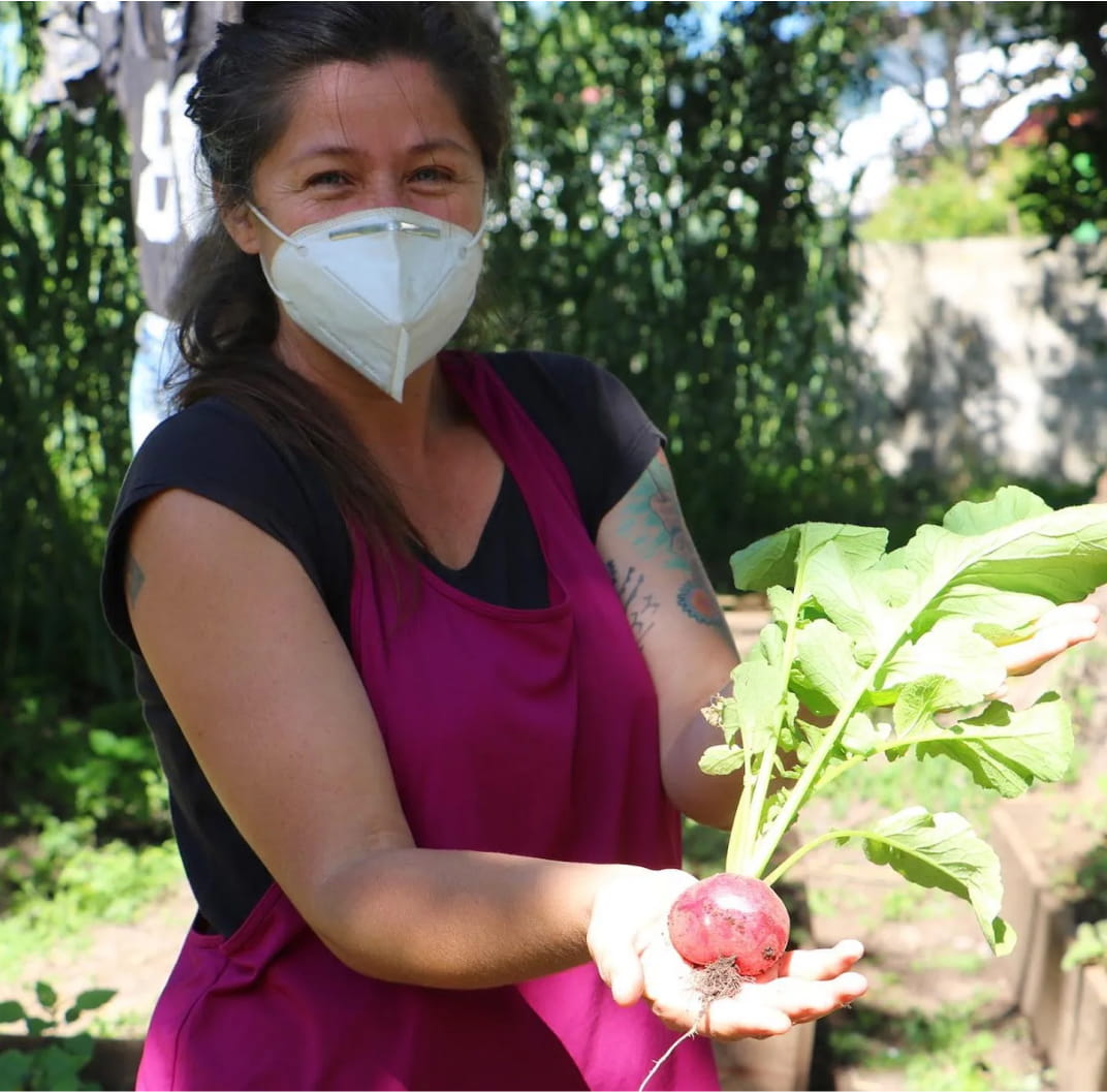 Creating-Resilient-Communities-woman-holding-beet-mask