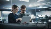 two-people-looking-at-laptop