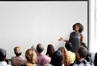 woman-at-whiteboard-teaching-class
