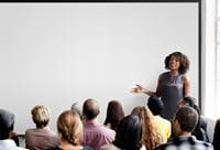 woman-at-whiteboard-teaching-class