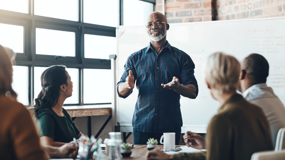 man-talking-to-group-in-meeting
