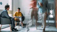 man-and-woman-sitting-in-busy-area