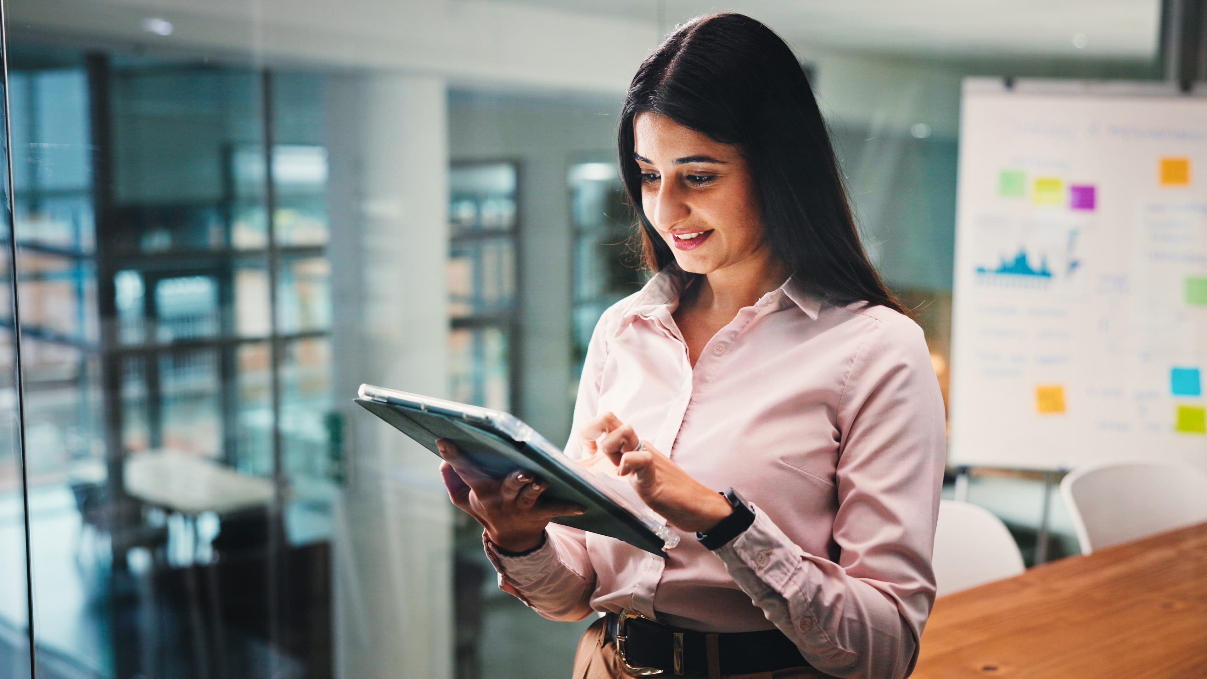 woman-looking-and-smiling-at-tablet