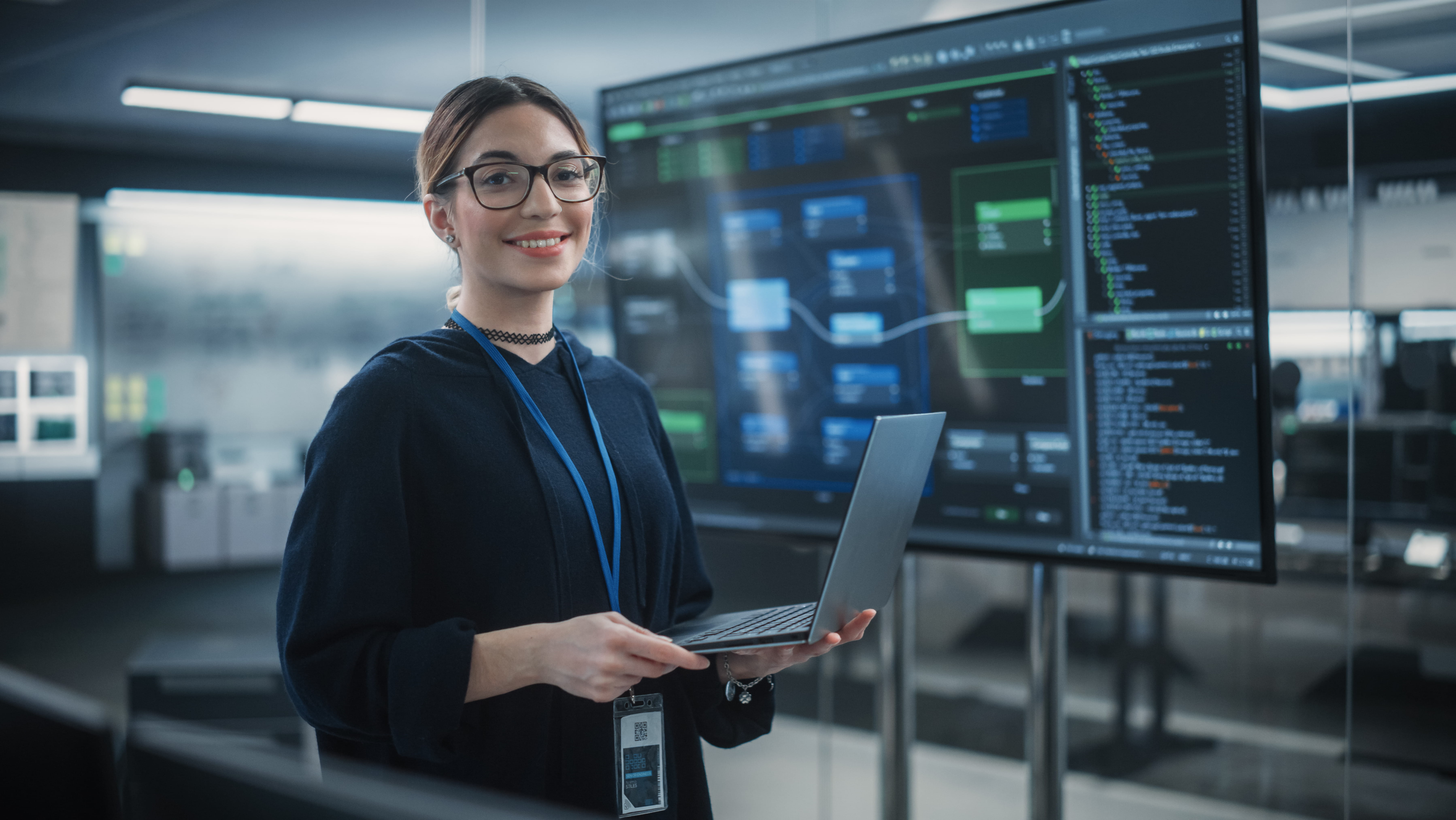 woman-smiling-holding-laptop