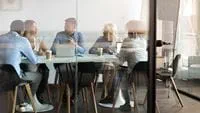 team-gathering-around-table