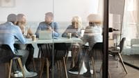 team-gathering-around-table