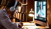 man-with-headphones-listening-to-training-on-computer
