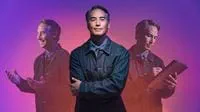 man-standing-with-arms-crossed-in-front-of-purple-pink-gradient