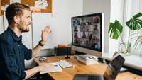 man-sitting-at-desk-on-zoom-call