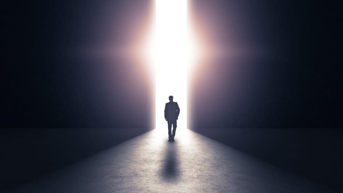person-walking-in-tunnel-toward-light