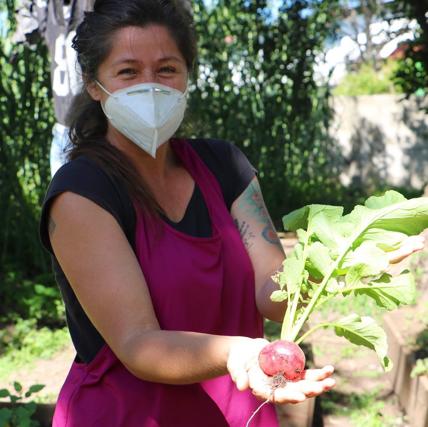Creating Resilient Communities: Woman holding beet wearing a mask