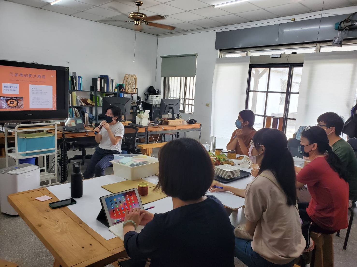 Group of students listening to teacher in classroom