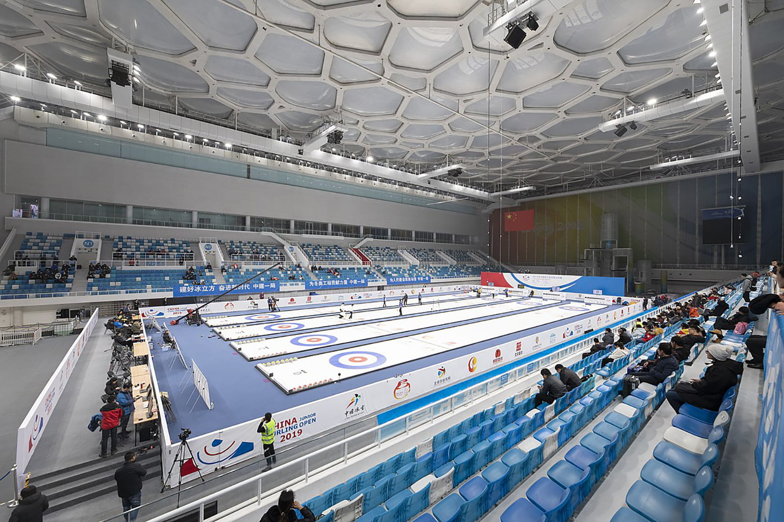 Beijing is repurposing legacy projects from the 2008 summer Olympics, including using the National Aquatics Centre as the "Ice Cube," with four curling rinks built on top of the pools.