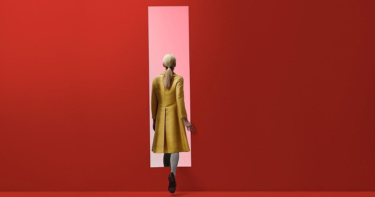 woman-walking-into-pink-door