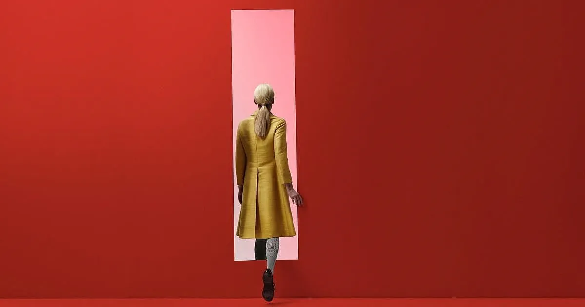 woman-walking-into-pink-door